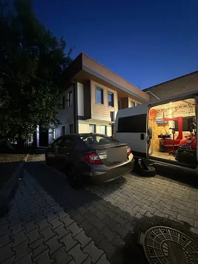 Akşam saatinde kapısı açık mobil lastik servis aracı ve içindeki sökme-takma makinesi